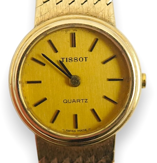 A lady's early 1980's 9ct gold Tissot quartz wrist watch with textured 9ct gold associated bracelet